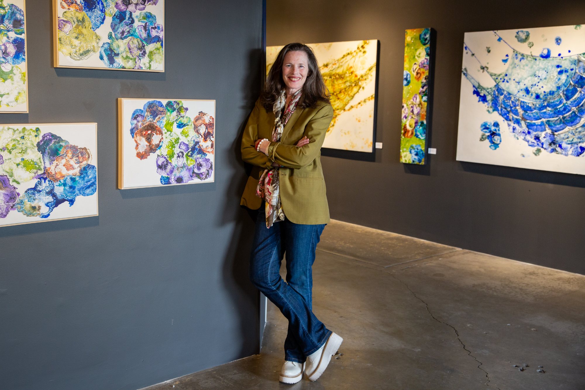 Artist Colleen Flynn-Lawson with her paintings