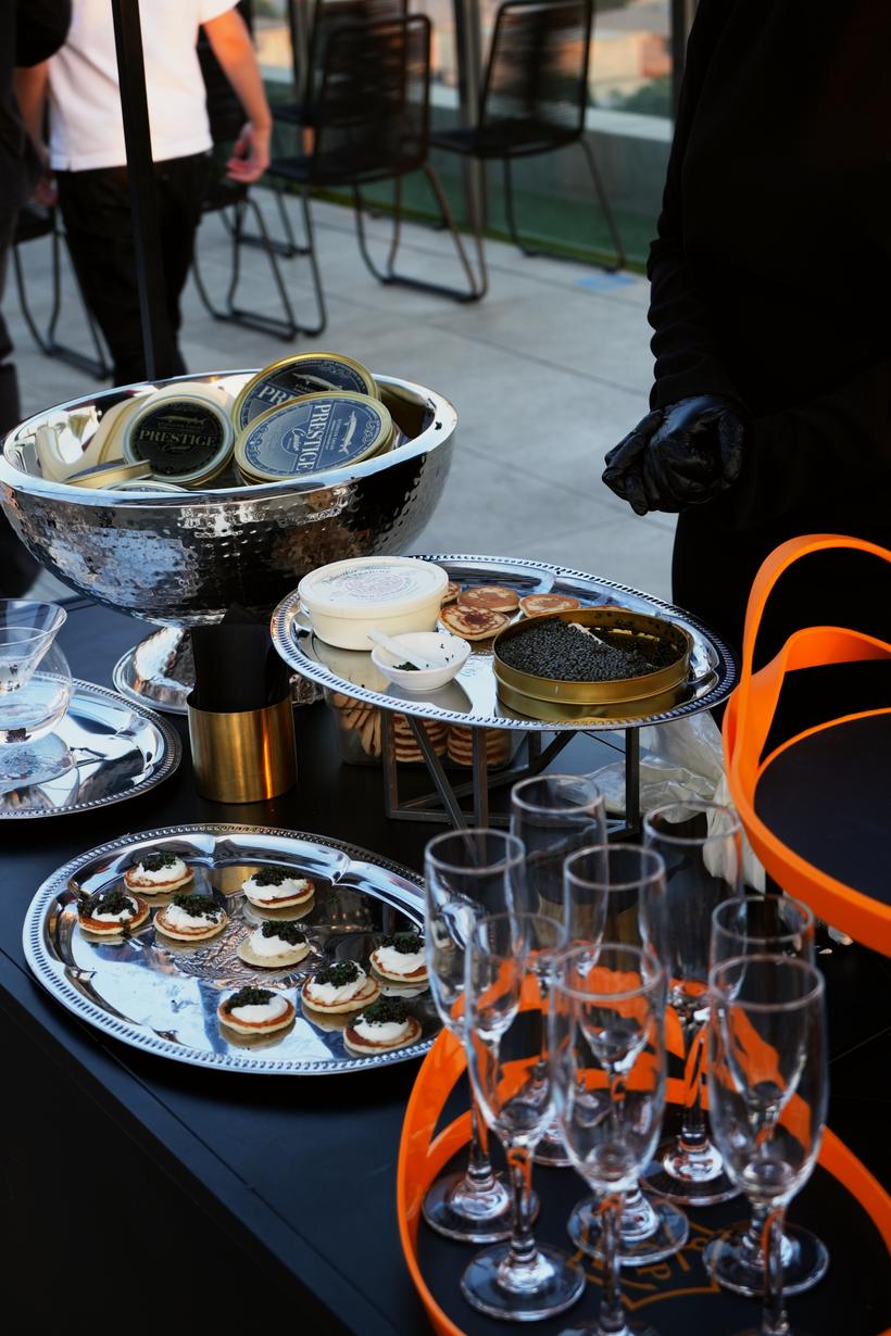 Caviar tins on ice with blini and champagne flutes
