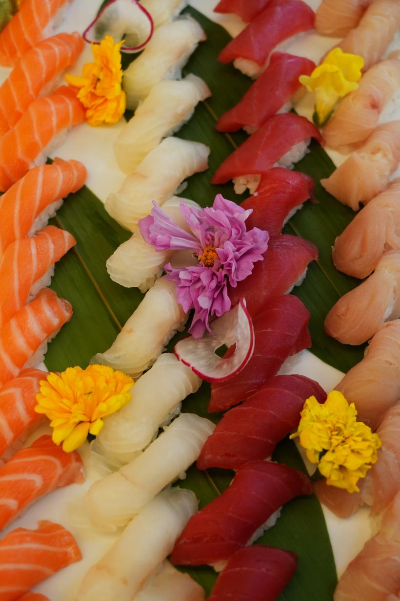 Nigiri and signature rolls plated with edible flowers